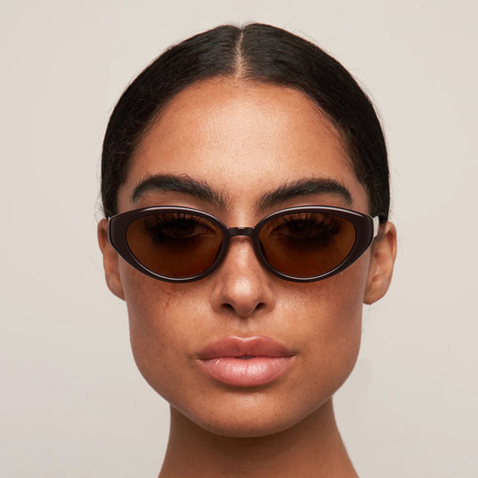 Person wearing dark sunglasses against a plain background