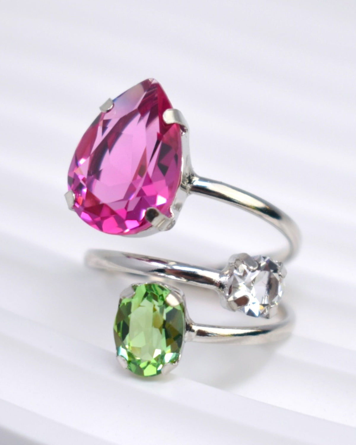 Two silver rings with pink and green gemstones on a white background
Material: sterling silver, rhodium plated, bright pink, white and light green Swarovski crystals
Color: silver, bright pink, white and light green
Ring type: statement
Size: 7.5