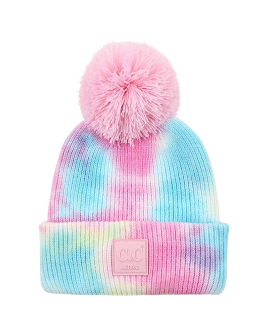 Tie-dye beanie with pink pom-pom and pink logo patch on a white background