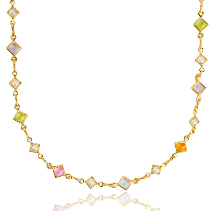 Gold necklace with colorful gemstones on a white background