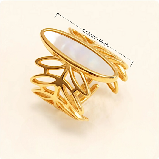 Gold ring with leaf-like design and measurements on a beige background
