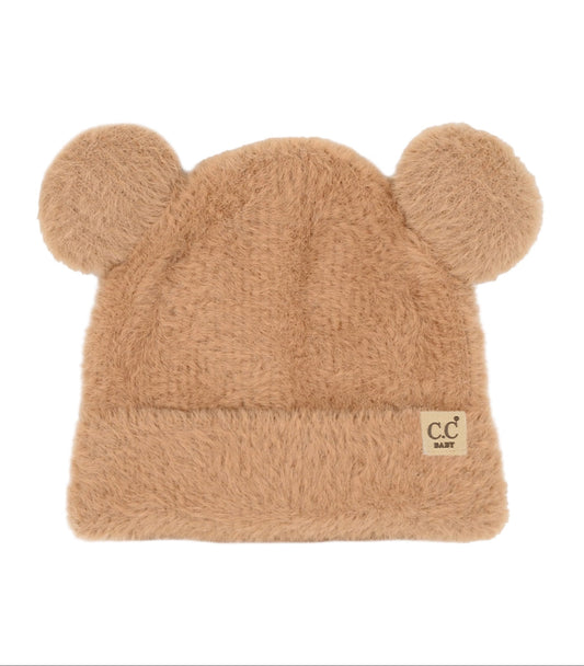 Beige fuzzy hat with ear designs on a white background