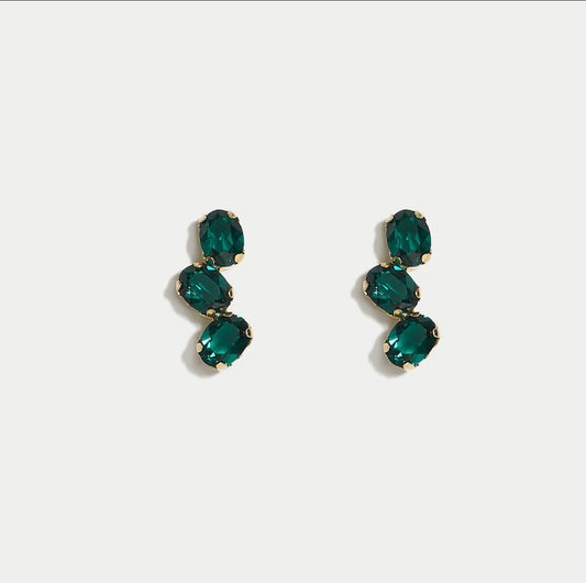 Pair of green swarovski crystals earrings on a white background