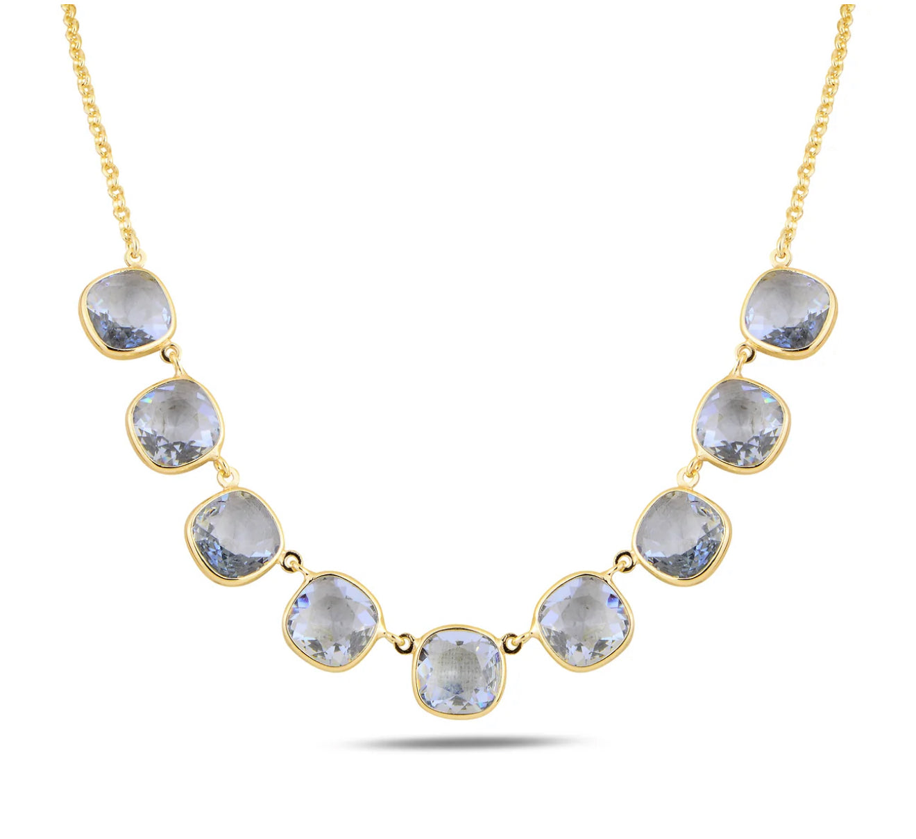 Gold necklace with blue crystals on a white background
Material: 925 sterling silver, gold-plated, cushion cut translucent light Aquamarine Swarovski crystals
Color: gold, light blue
Measurement: 14" length, 1" extension, 1 mm wide chain