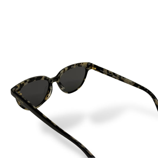 Sunglasses with tortoiseshell frame and dark lenses on a white
background