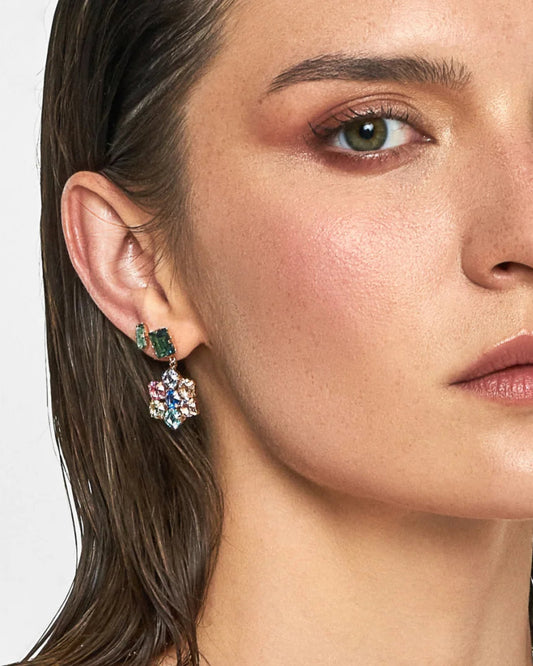 Close-up of a woman wearing a floral earring with green gemstones on a white background
Material: Sterling Silver, Rose Gold Plated, multi-colored Swarovski Crystals
Color: sterling silver, yellow gold, pink, blue, green, purple
Measurement: 3 mm thickness, 2.5 cm length, 1.5 cm width