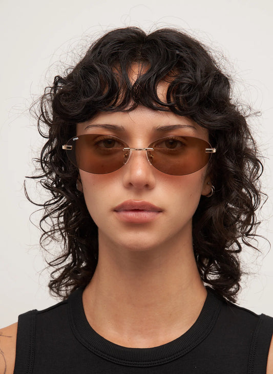 Person wearing sunglasses with a neutral background