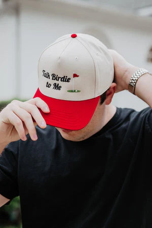 Person wearing a red and white cap with text, blurred background