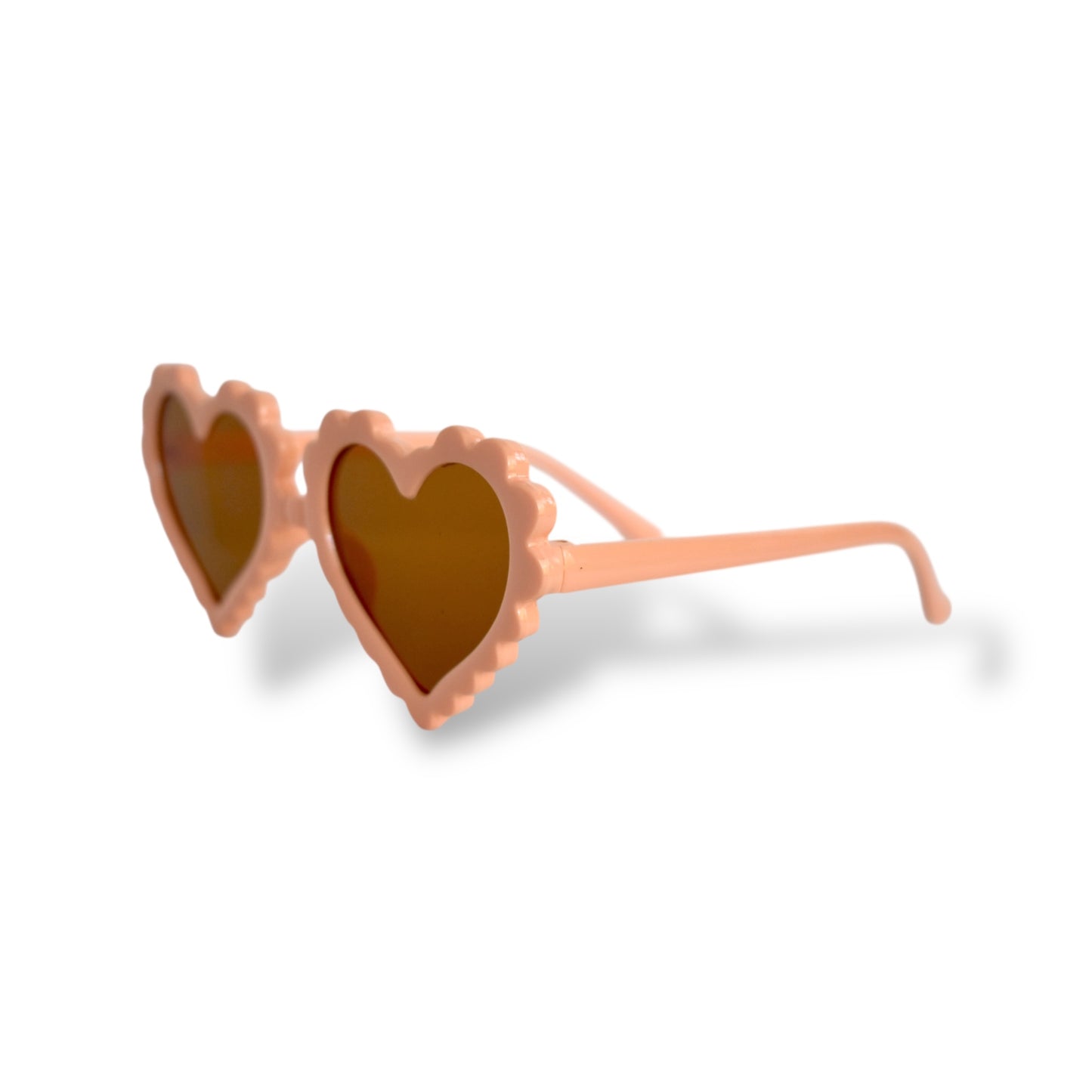 Heart-shaped sunglasses with a peach frame on a white background