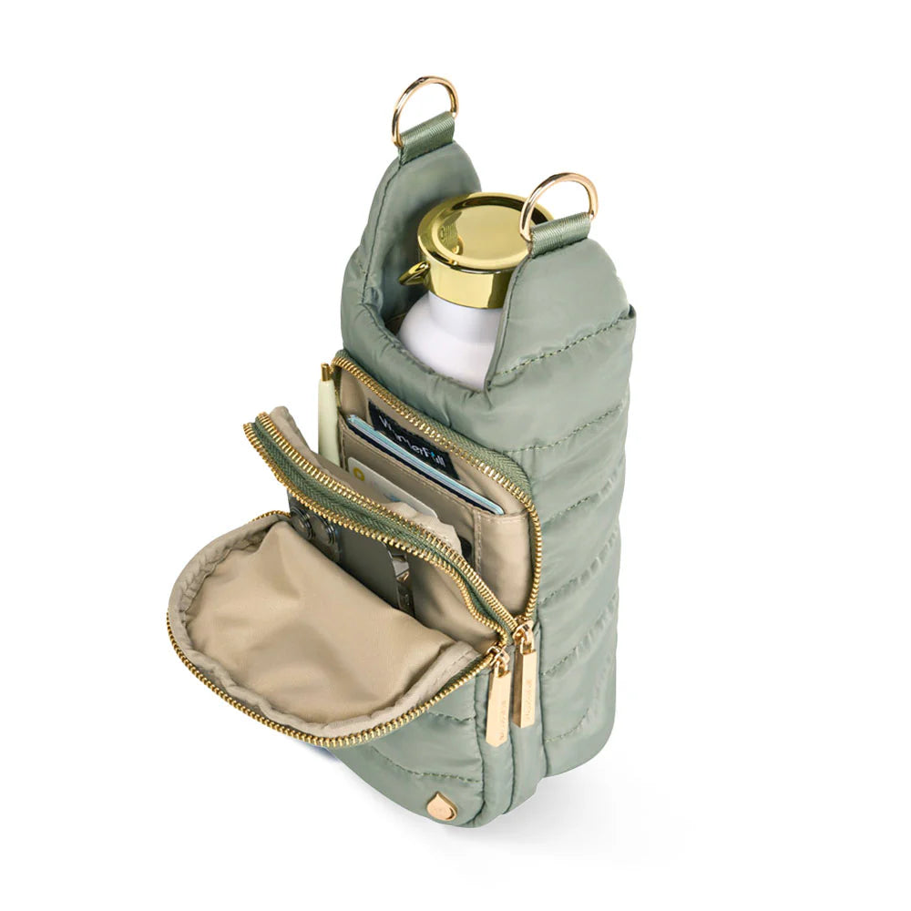 Green pouch with gold zipper and interior pocket, containing a white bottle with gold cap.