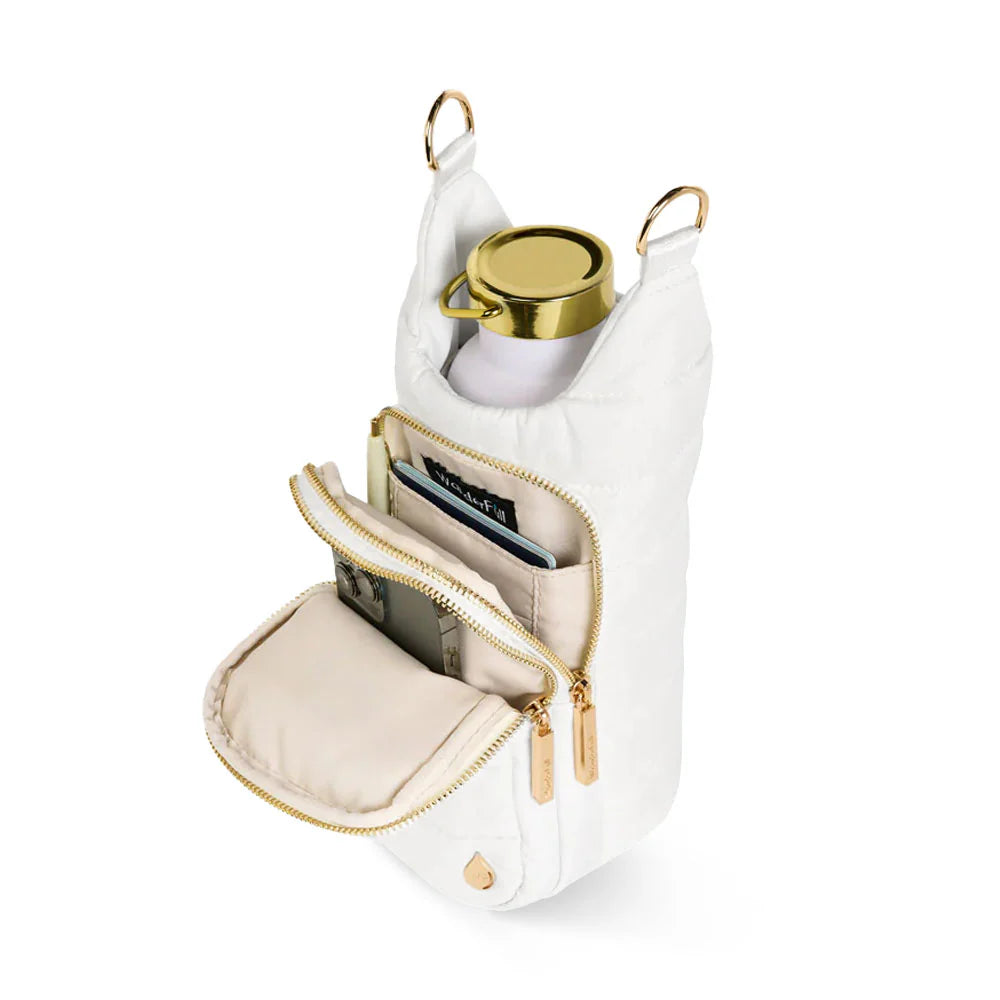 White handbag with gold accents containing a phone, card, and small round item on a white background