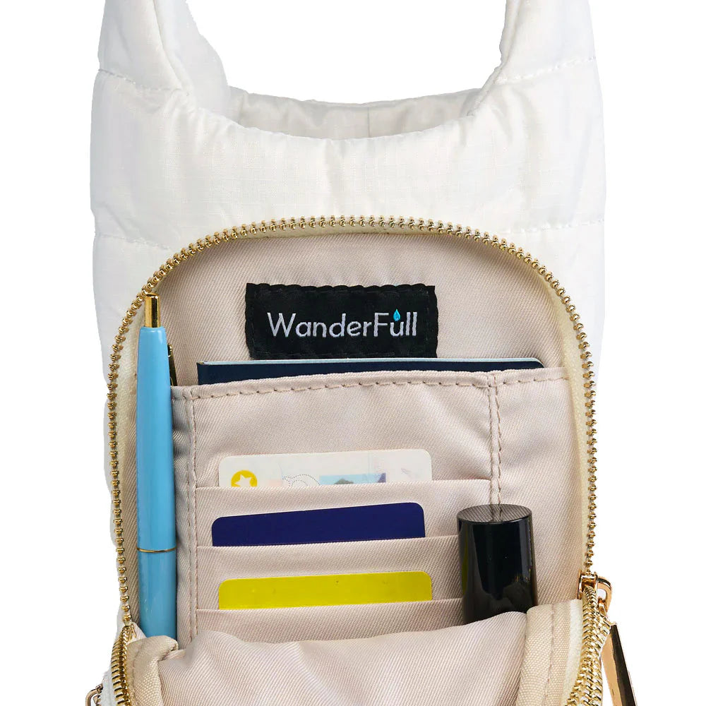 White crossbody bag with gold zipper, containing a pen and cards, on a white background.