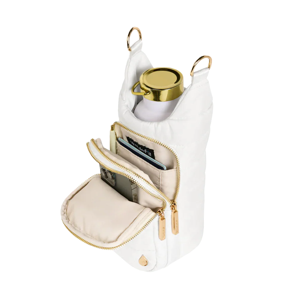 White handbag with gold accents containing a phone, card, and small round item on a white background