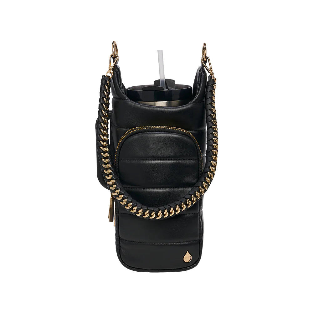 Black leather bag with gold chain strap and cup holder on a white background