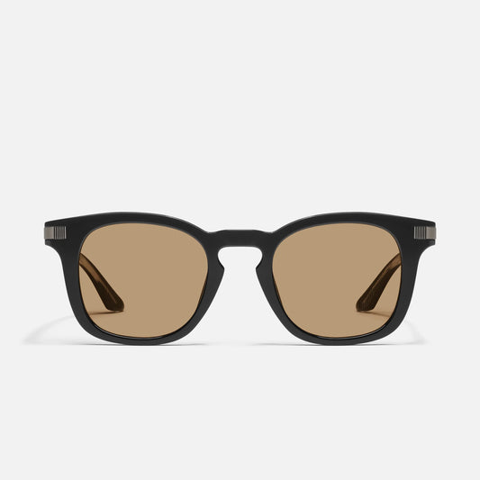 Black sunglasses with brown lenses on a white background