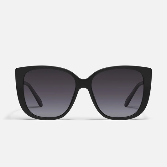 Black sunglasses with dark lenses on a light gray background