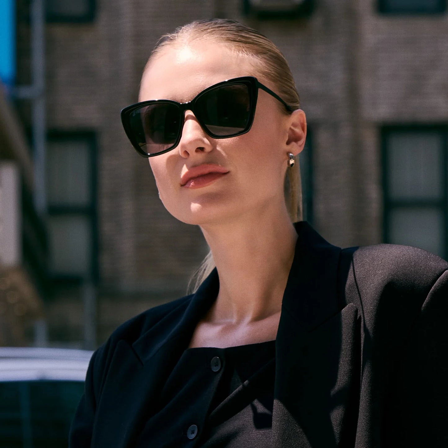 Woman wearing black sunglasses and a black outfit outdoors