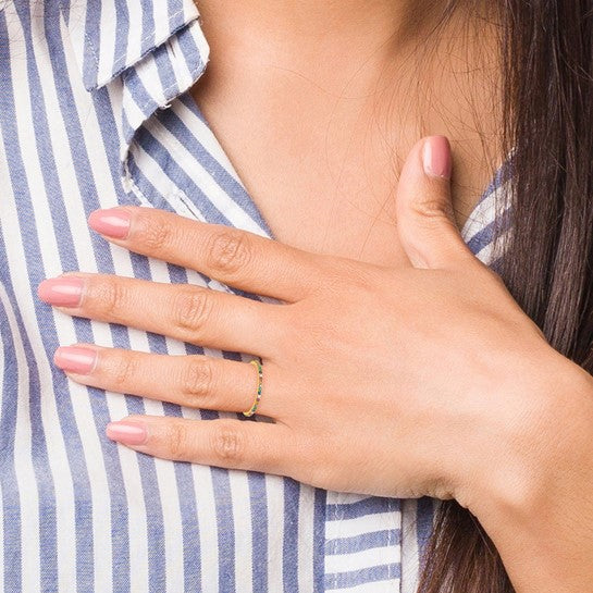 Close-up of a person wearing a gold ring on a blue and white striped shirt.
Material: sterling silver, 14K yellow gold plated, colorful CZ stones
Color: yellow gold
Style: stackable, infinity stone design
Measurement: 1.7 mm width, size 7