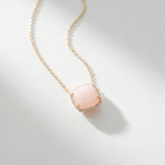 Necklace with a pink pendant on a light gray background