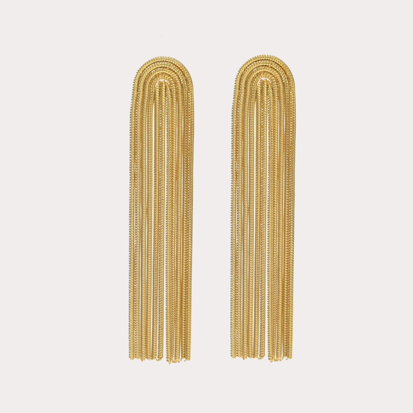 waterfall style gold drop earrings on white background