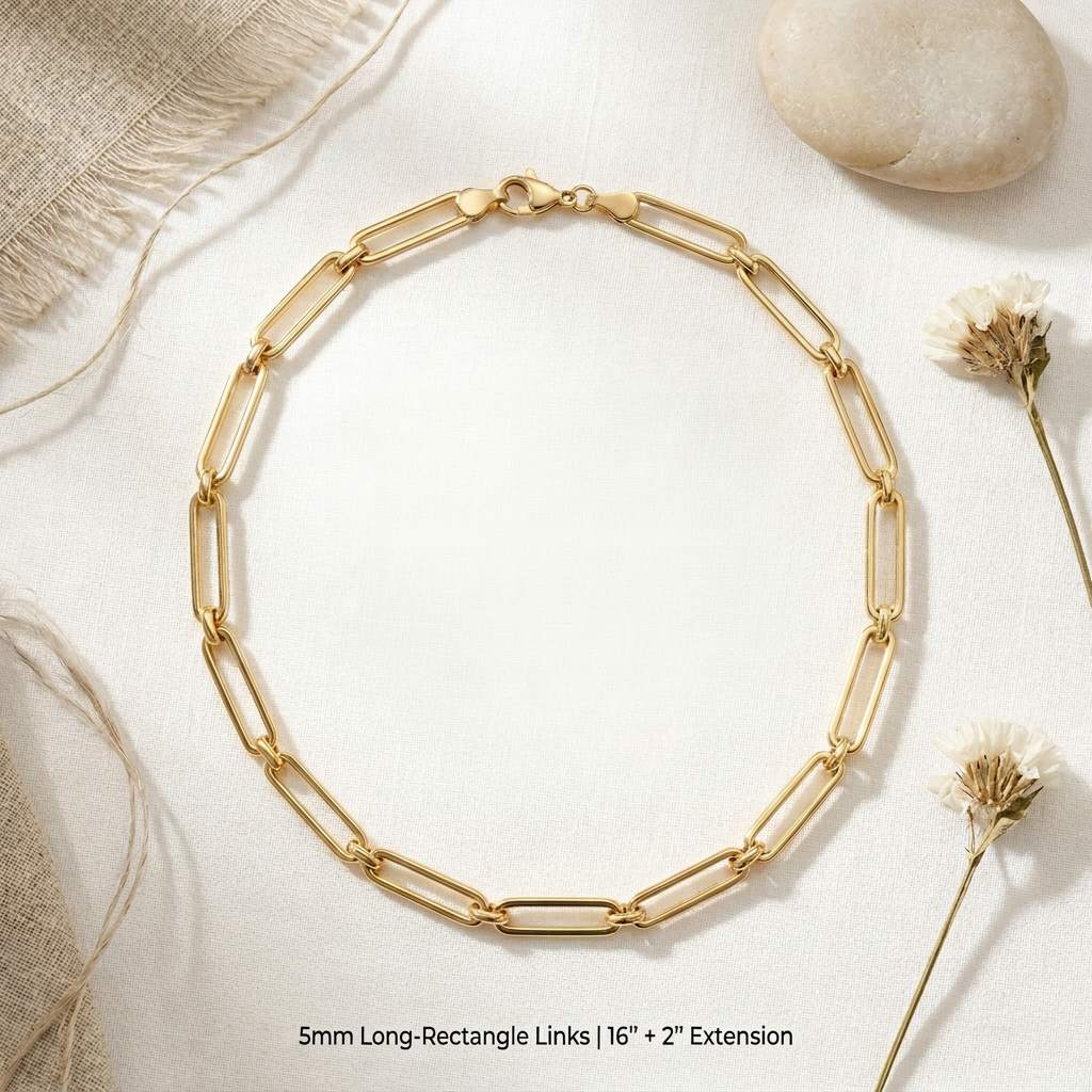 Gold chain necklace on a light background with natural elements