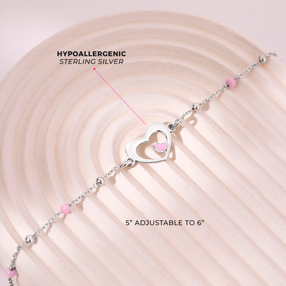 Age Group: Adorable for Toddlers, Young Girls & Preteens; Safe for Sensitive Skin
Material: 925 Sterling Silver
Bracelet Size: 5 inches with extension up to 6", heart & round beads (pink enamel); Adjustable
Metal Stamp: 925
[picture of heart bracelet with measurements and materials listed