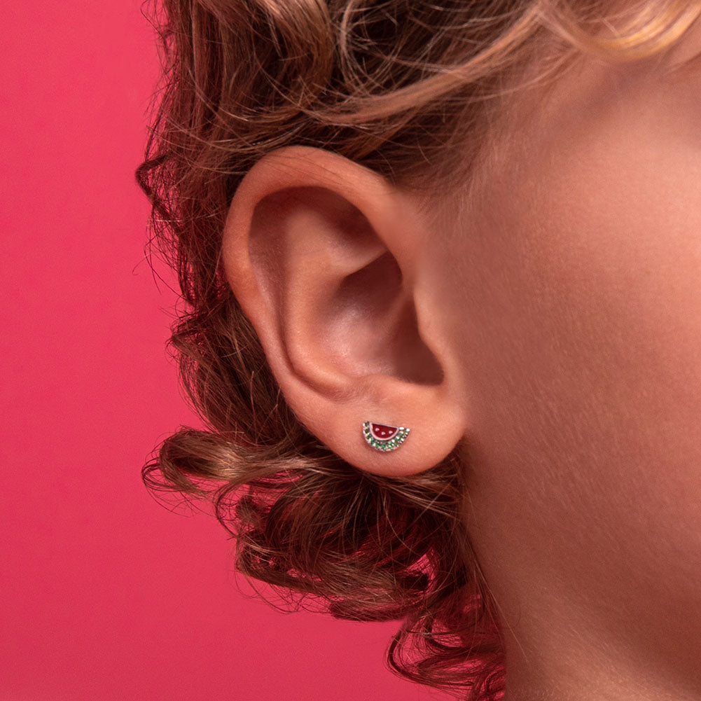 Age Group: Ideal for Toddlers and Little Girls
Size: 9mm W x 5mm H (green) watermelon; 7mm threaded earring post
Material: 925 Sterling Silver
Stone: Cubic Zirconia
Metal Stamp: 925
Window Box Included
Picture of earrings on a little girl's ear close up
