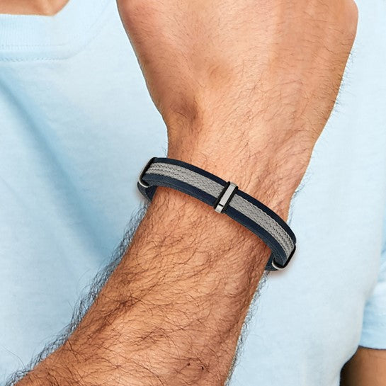 Person wearing a black and gray woven bracelet on a light blue
Material: stainless steel, blue leather, wire
Color: silver, blue, grey
Closure: buckle clasp
Measurement: 8.5" circumference