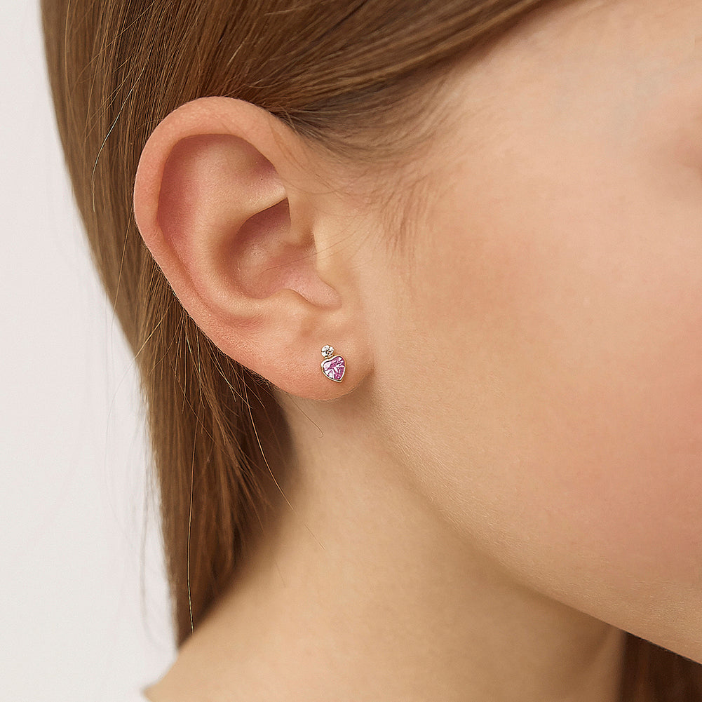 Age Group: Adorable for Infants, Toddlers & Little Girls; Safe for Sensitive Skin
Material: 14k Yellow Gold
Earring Size: 5mm W x 6mm H (pink) heart, (clear) round cubic zirconia; 8mm threaded post
Main Stone: Clear & Pink Cubic Zirconia
Metal Stamp: 14k
picture of gold and pink heart earrings on a young girls ear