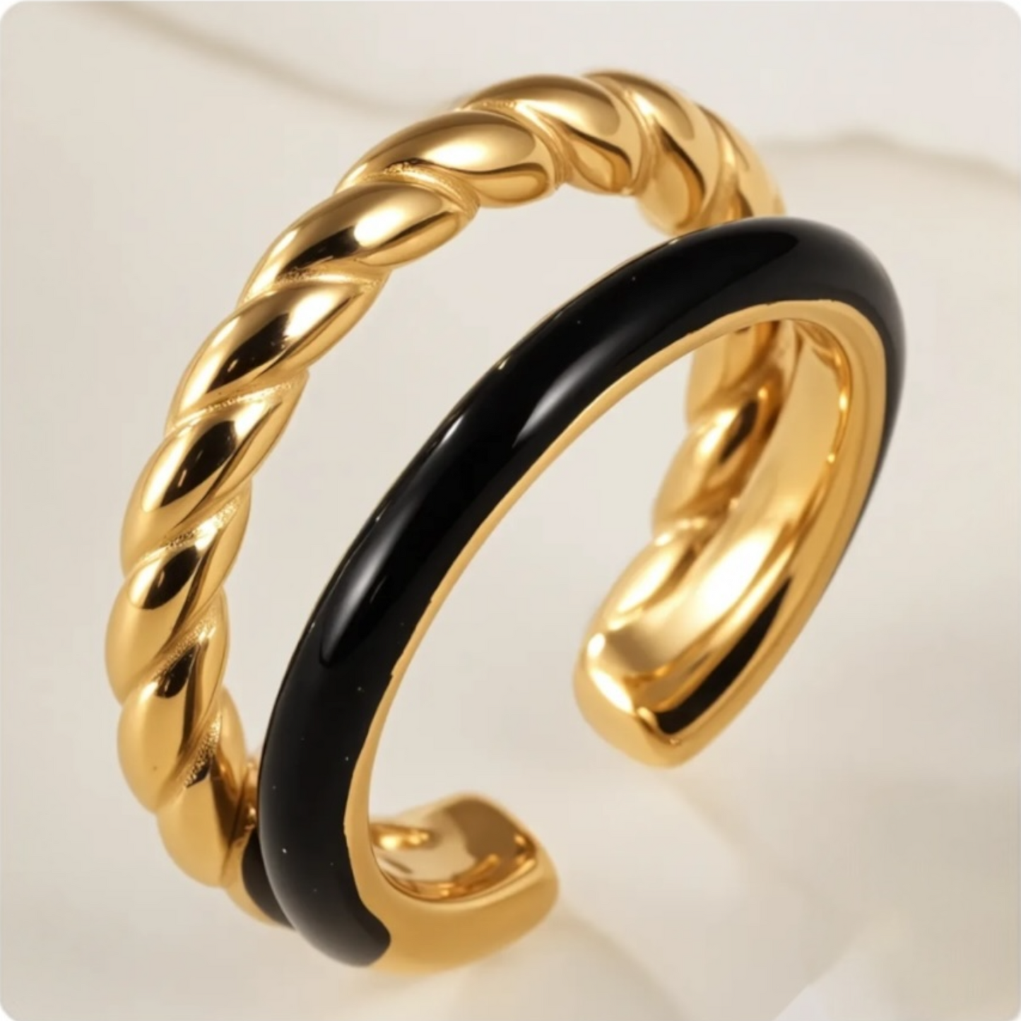 Gold and black ring on a white background