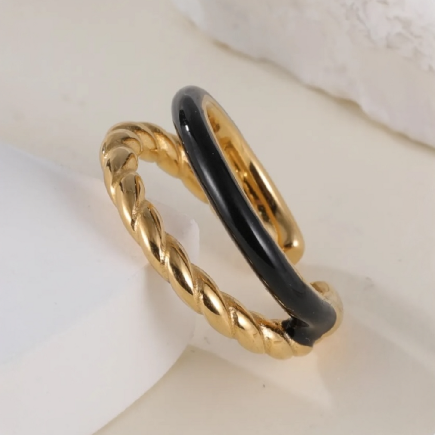 Gold and black ring on a light background