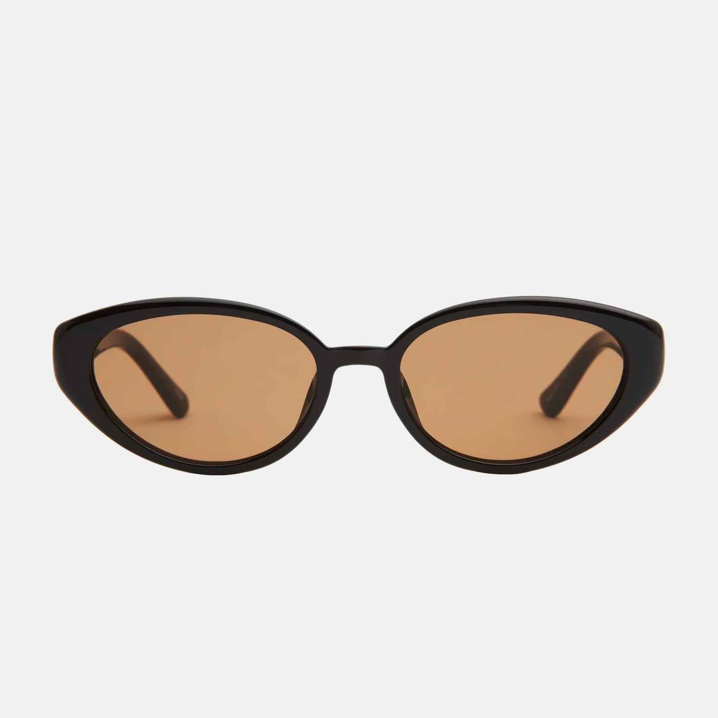 Cat-eye sunglasses with brown lenses on a light gray background