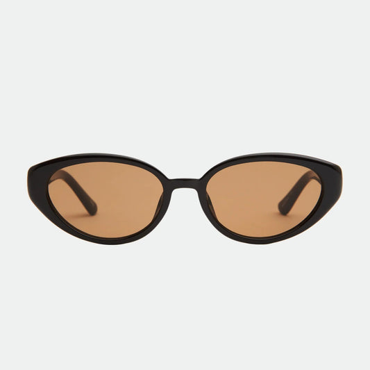 Cat-eye sunglasses with brown lenses on a light gray background