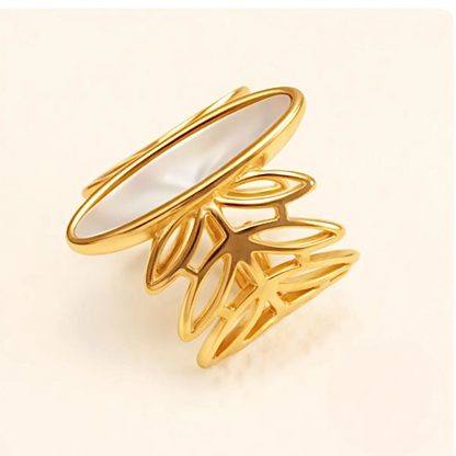 Gold ring with a white interior on a beige background