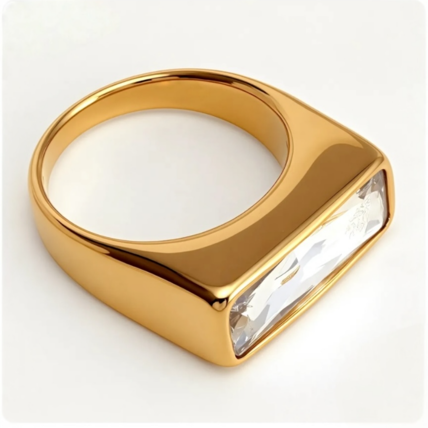 Gold ring with a large clear gemstone on a white background