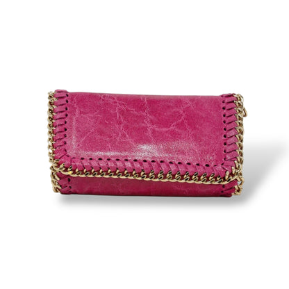 Pink handbag with gold chain on a white background