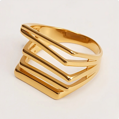 Gold ring with geometric design on a light beige background