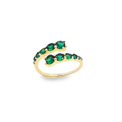 Gold ring with green gemstones on a white background
