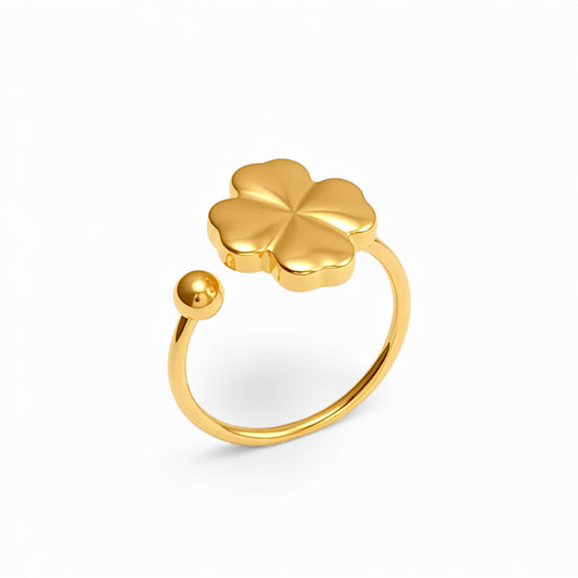 Gold four-leaf clover ring on a white background