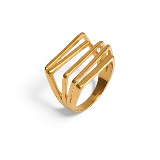 Gold ring with a geometric design on a white background