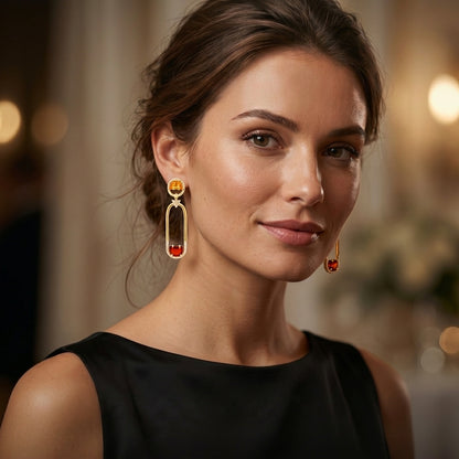 Woman wearing gold earrings with a blurred background