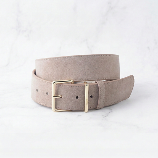 Beige belt with a gold buckle on a light gray background