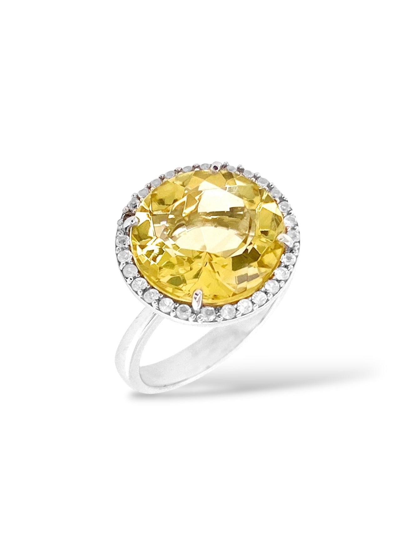 A yellow round-cut ring with a halo of small clear stones and a polished silver band, shown on a clean white background.