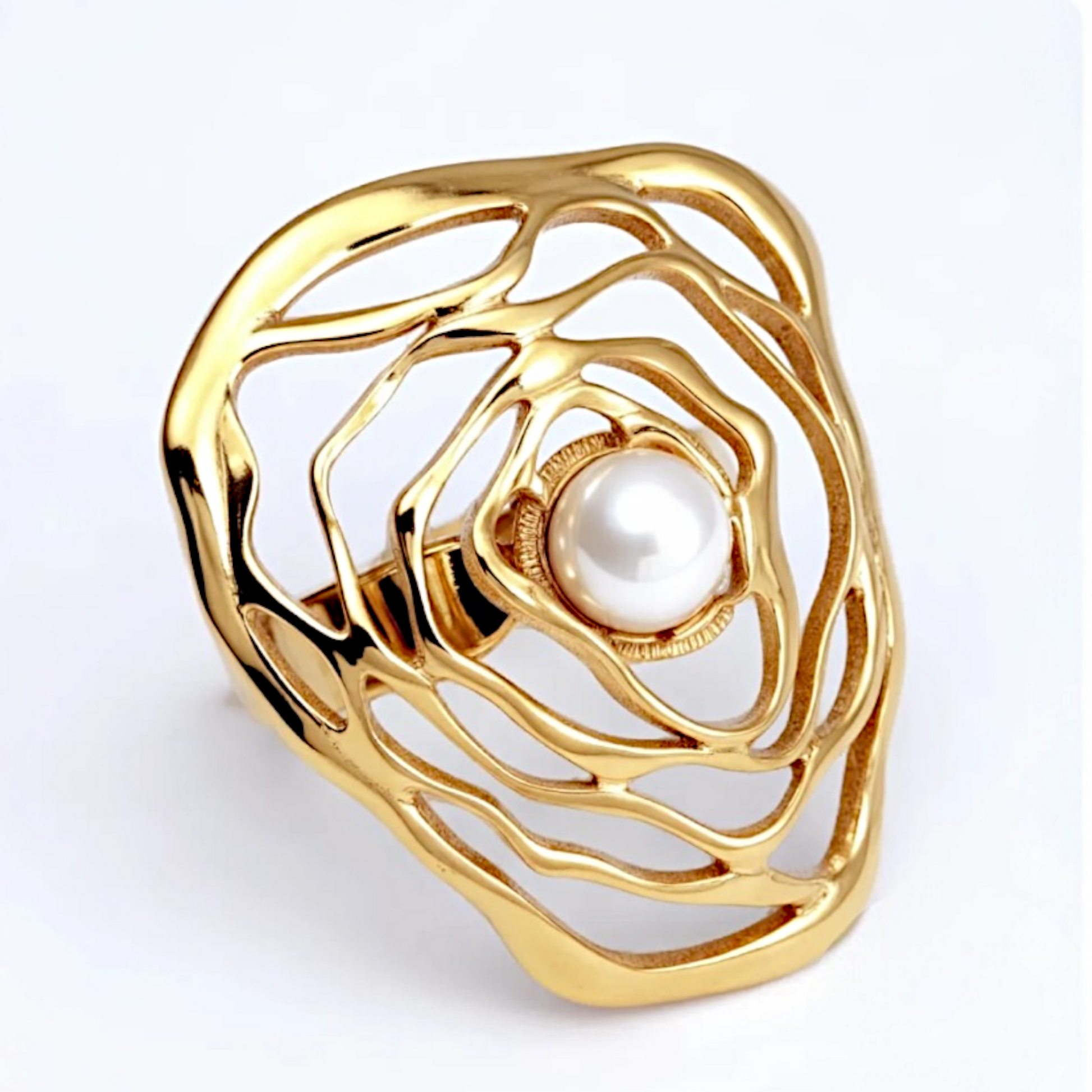 Gold ring with a pearl at its center on a white background