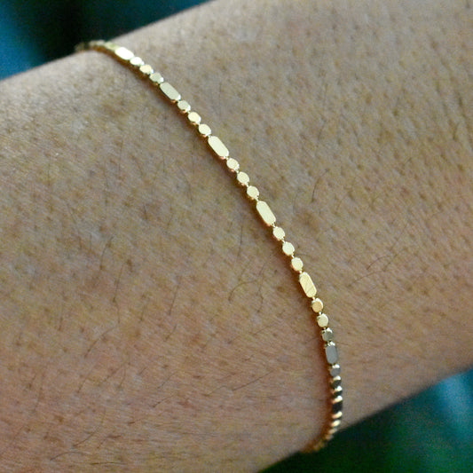 gold bracelet on person's wrist