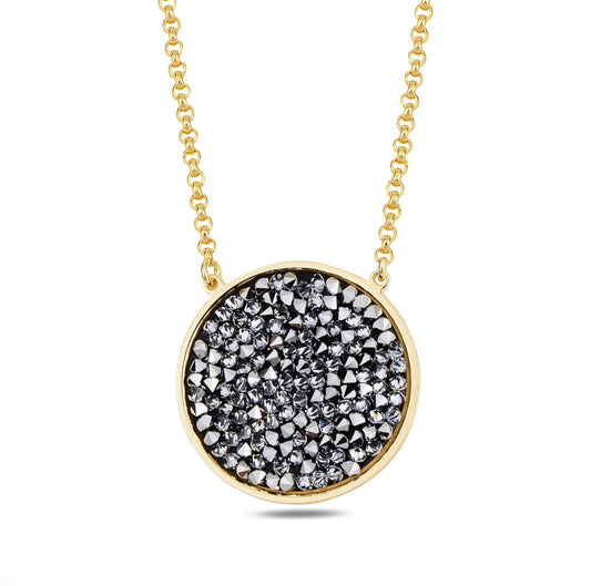 Gold necklace with a round pendant featuring black and silver stones on a white background