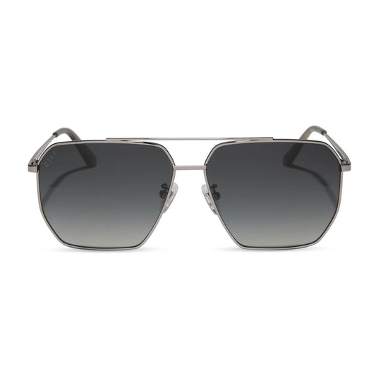 Sunglasses with a metallic frame and dark gradient lenses on a white background