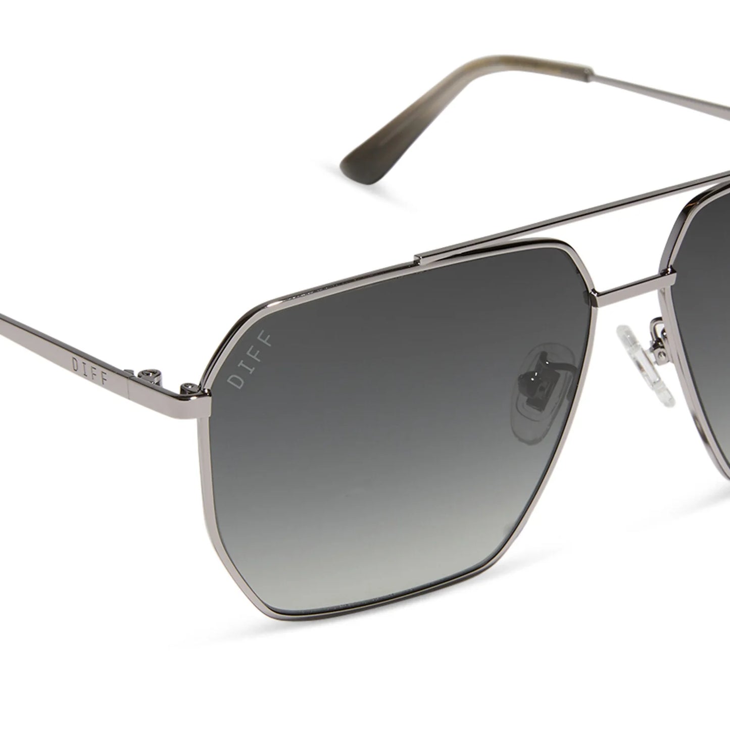 Sunglasses with gradient lenses and metallic frame on a white background