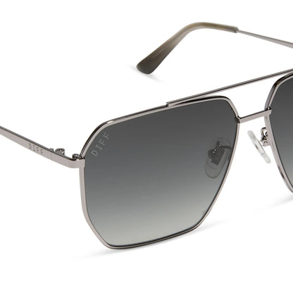 Sunglasses with gradient lenses and metallic frame on a white background