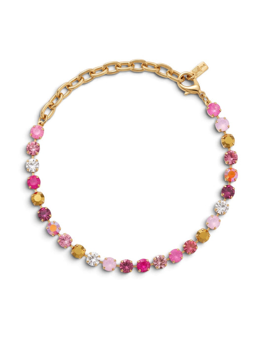 A gold chain bracelet adorned with a row of round, faceted gemstones in shades of pink, yellow, orange, and clear, displayed on a clean white background.